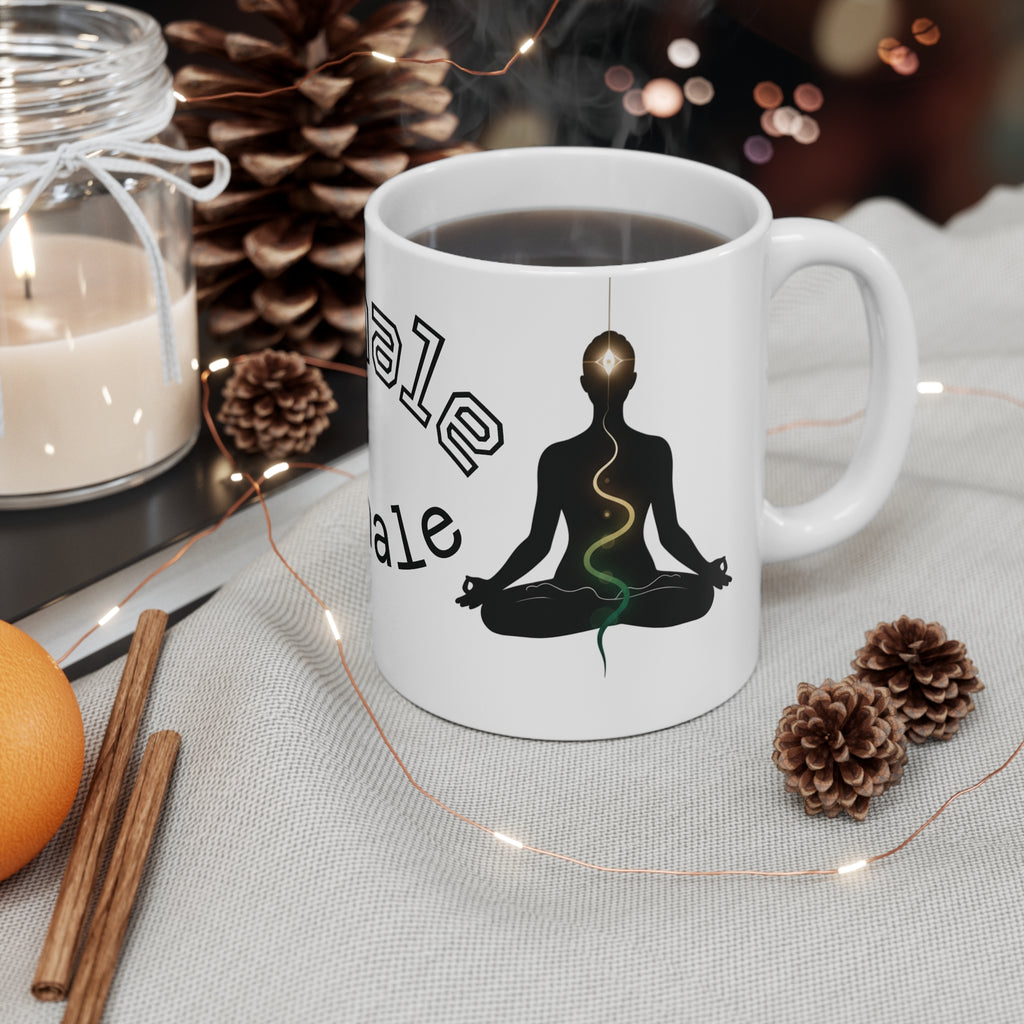 Meditation yoga coffee mug with a serene silhouette, chakra line, and 'Inhale Exhale' text, resting on a cozy table.